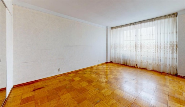 unfurnished room featuring light parquet flooring