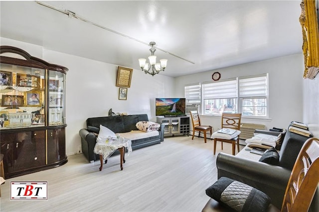 living room with an inviting chandelier and wood finished floors