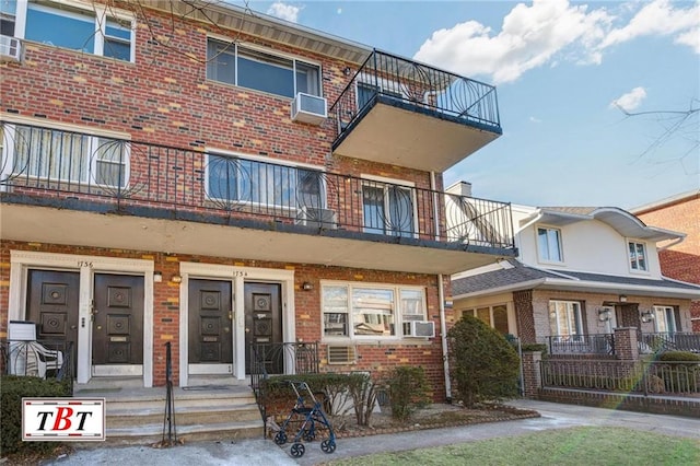 view of front of property with a balcony and cooling unit