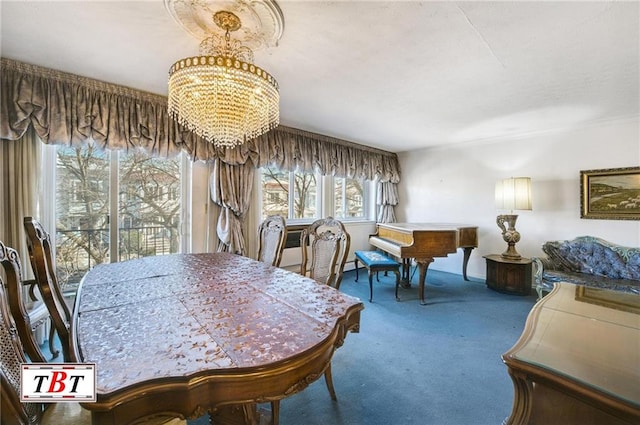 carpeted dining room featuring a chandelier