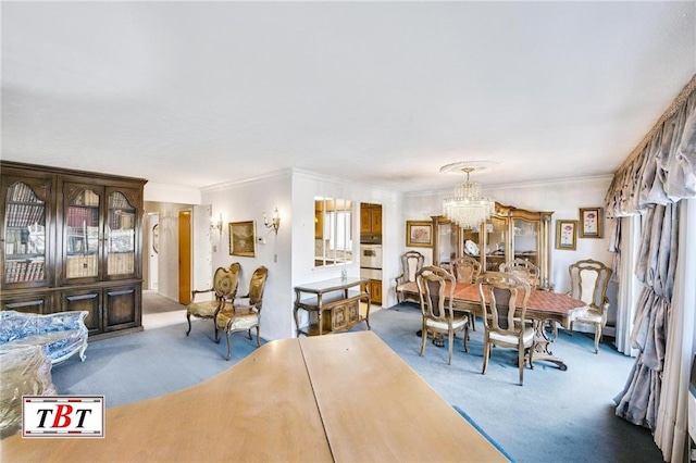 dining space featuring ornamental molding, carpet floors, and a notable chandelier