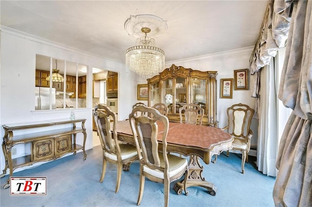 dining room with an inviting chandelier, ornamental molding, and carpet flooring