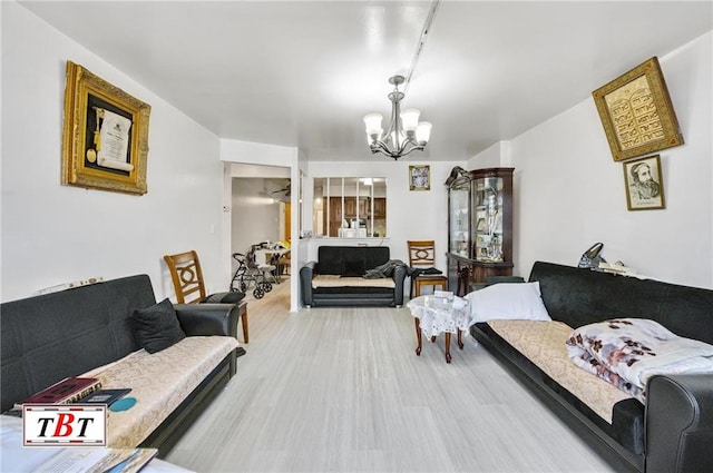 living room with a chandelier and wood finished floors