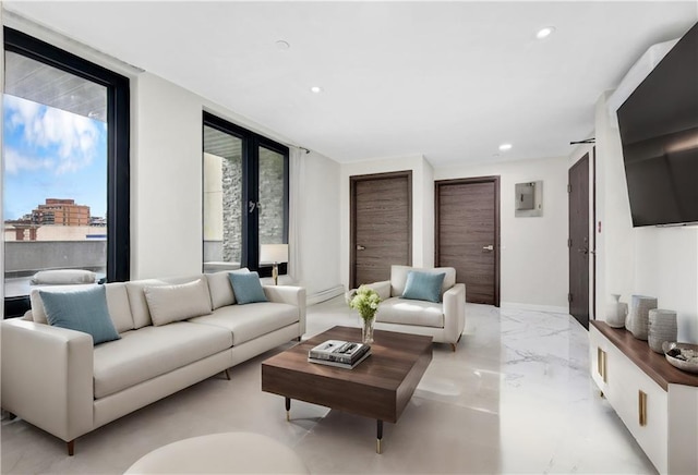 living area featuring a wall of windows, recessed lighting, and marble finish floor