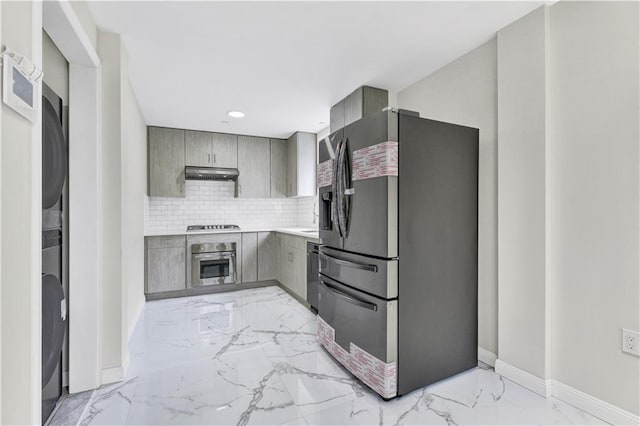 1014 Banner Ave Unit 2B, Brooklyn, NY 11235 - kitchen featuring stainless steel appliances, baseboards, under cabinet range hood, gray cabinetry, and marble finish floor