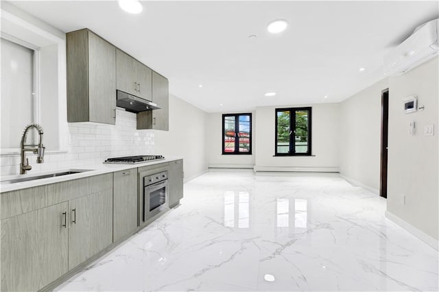 kitchen featuring under cabinet range hood, stainless steel appliances, a sink, marble finish floor, and a wall mounted air conditioner