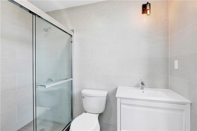 bathroom featuring vanity, toilet, and a stall shower