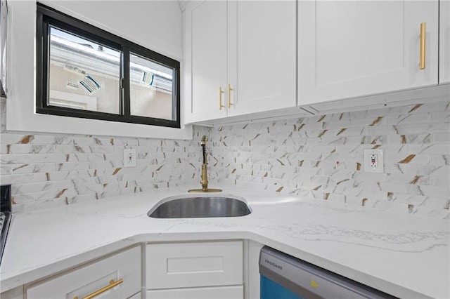 kitchen with white cabinetry, dishwashing machine, sink, and decorative backsplash