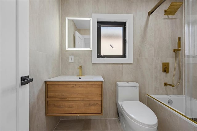 bathroom featuring tiled shower / bath combo, vanity, and toilet