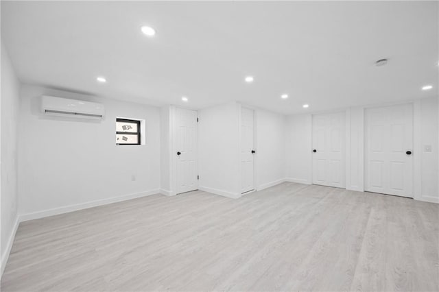 finished below grade area featuring baseboards, light wood-style flooring, and recessed lighting