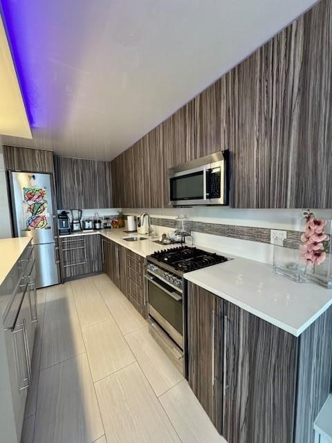 501 Surf Ave Unit 23B, Brooklyn, NY 11224 - kitchen featuring light countertops, a sink, modern cabinets, and stainless steel appliances