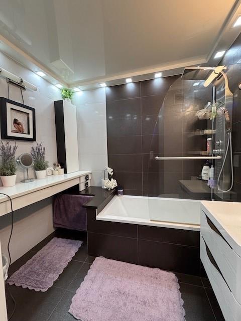 bathroom with vanity, tile patterned floors, and tiled shower / bath