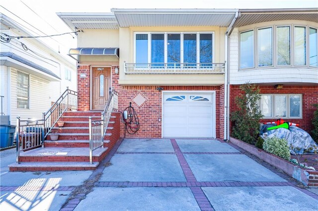 view of front of home featuring concrete driveway, an attached garage, and brick siding