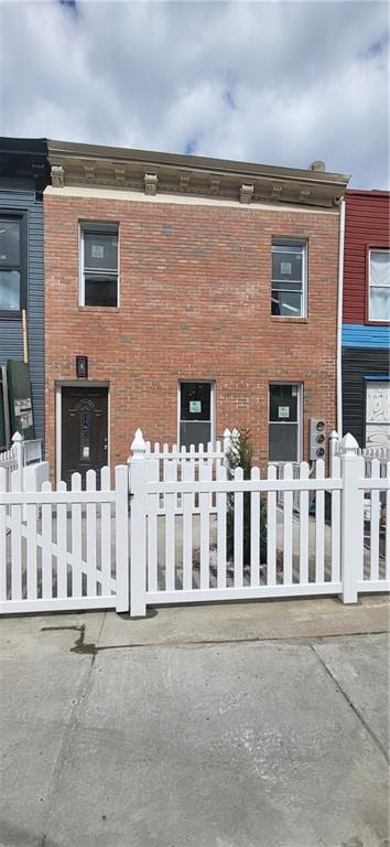 view of building exterior featuring a fenced front yard