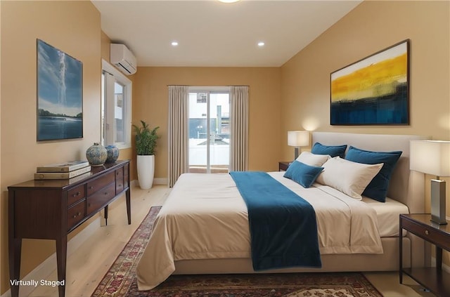 bedroom with an AC wall unit, recessed lighting, wood finished floors, and baseboards