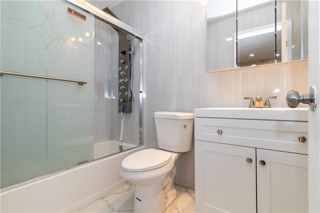 bathroom with vanity, toilet, marble finish floor, and shower / bath combination with glass door