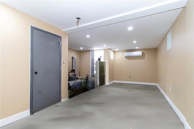 basement featuring recessed lighting, baseboards, and a wall mounted air conditioner