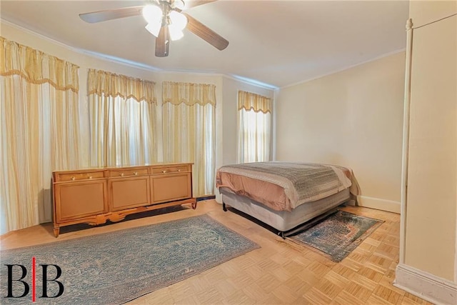 bedroom with crown molding, a ceiling fan, and baseboards