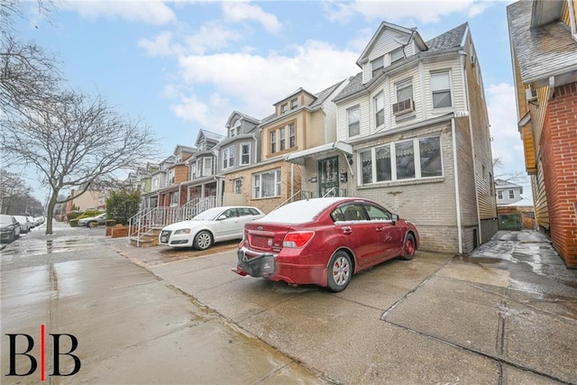 townhome / multi-family property featuring a residential view and brick siding