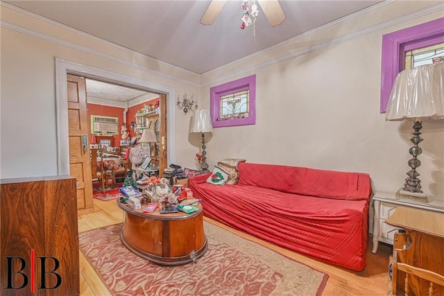 living room with ceiling fan, wood finished floors, and crown molding