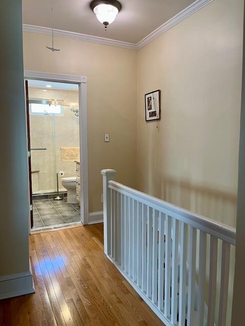 hall featuring hardwood / wood-style flooring and ornamental molding