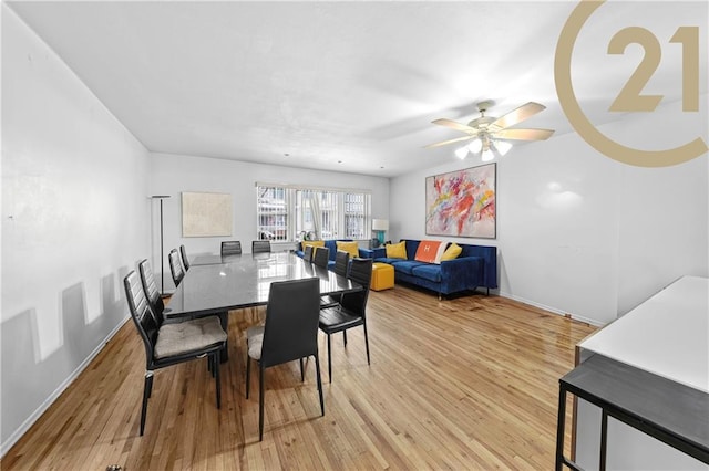 dining area with ceiling fan and light hardwood / wood-style flooring