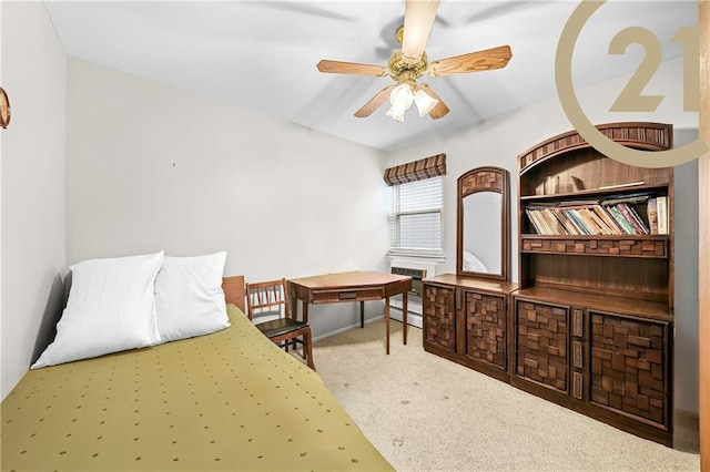 carpeted bedroom featuring ceiling fan and a baseboard heating unit