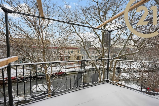 view of snow covered back of property