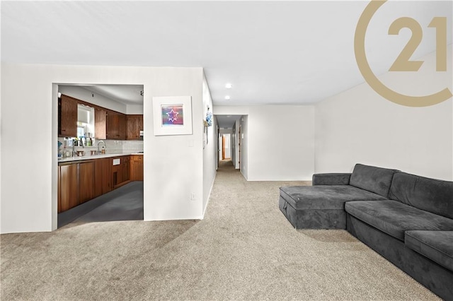 carpeted living room featuring sink