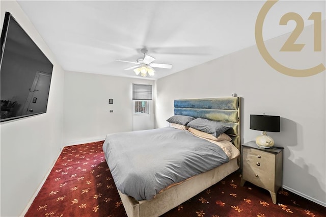 bedroom with dark colored carpet and ceiling fan