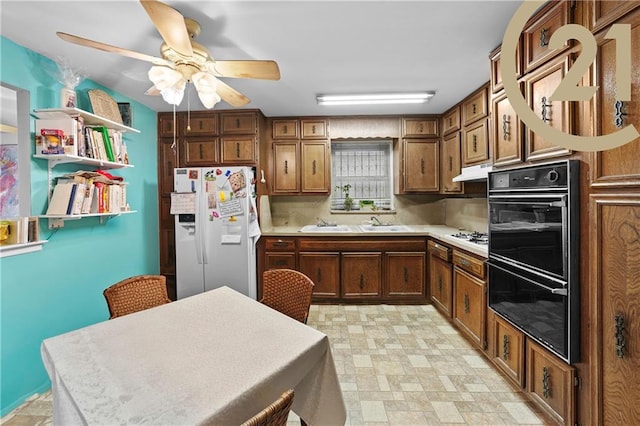 kitchen with sink, white appliances, and ceiling fan