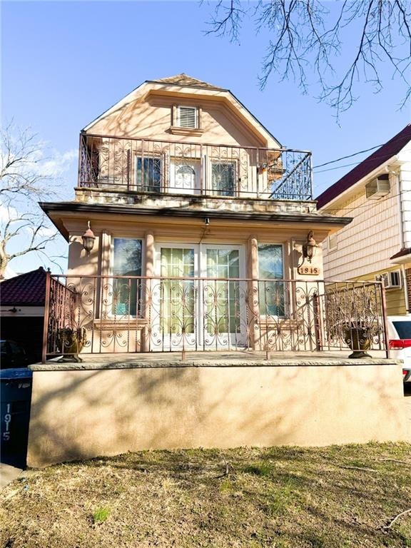 back of house featuring a balcony