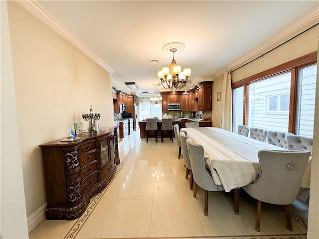 dining area featuring sink, crown molding, a chandelier, and light tile patterned flooring