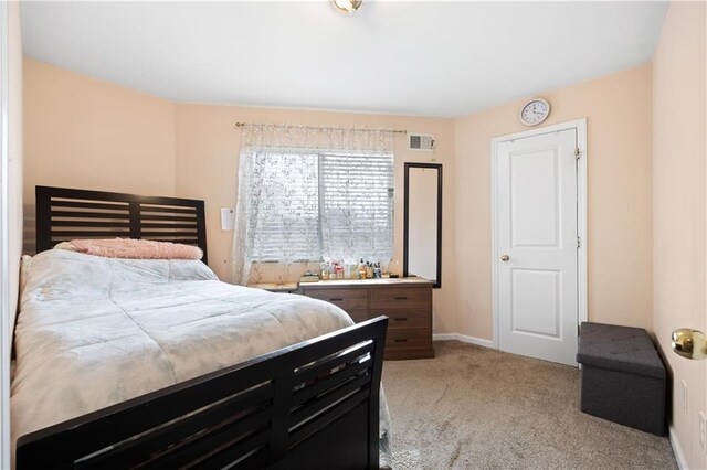 bedroom featuring light carpet