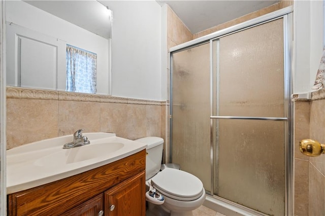 bathroom featuring vanity, tile walls, walk in shower, and toilet