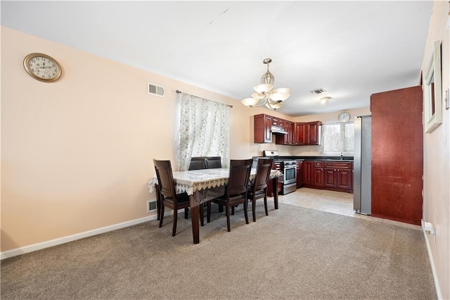 dining space featuring light colored carpet, a chandelier, and sink