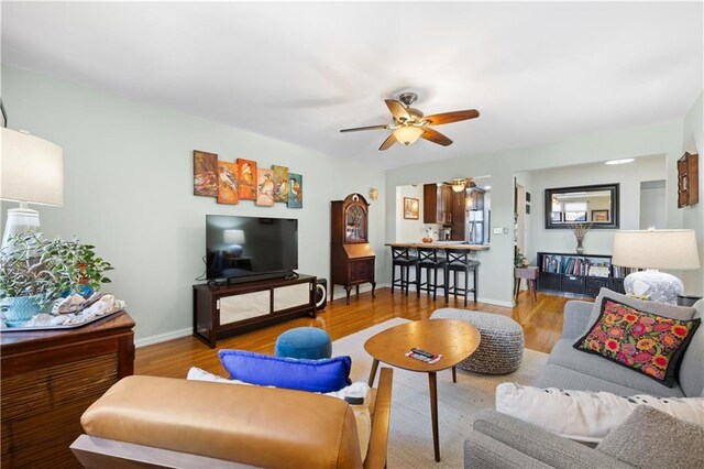 living room featuring ceiling fan and light hardwood / wood-style flooring