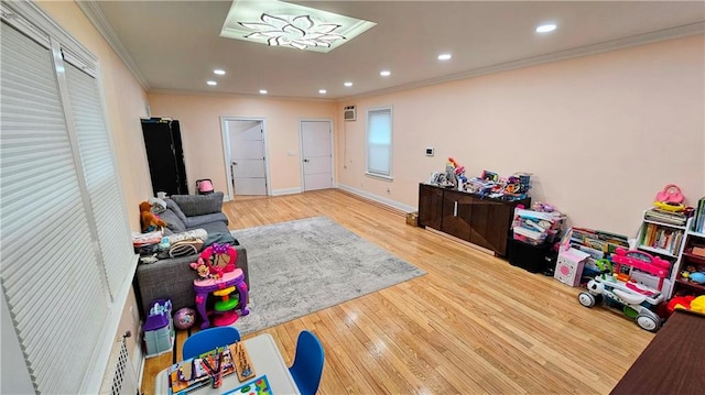 game room with hardwood / wood-style flooring and ornamental molding