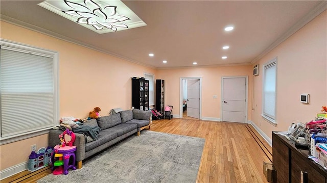 living room with crown molding and light hardwood / wood-style flooring