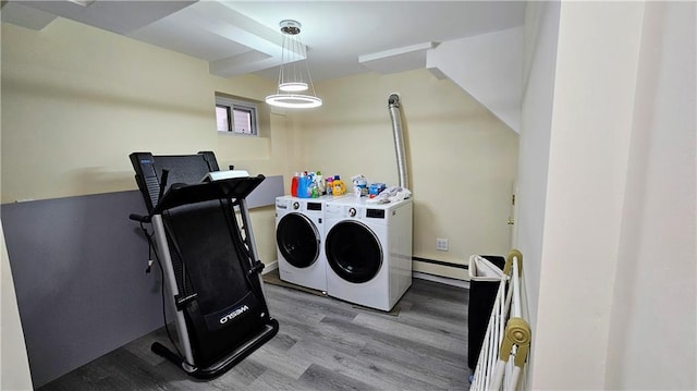 laundry room featuring separate washer and dryer and light hardwood / wood-style floors