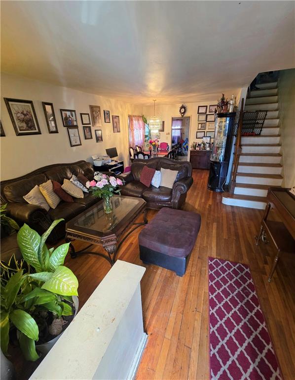 living room featuring stairway and hardwood / wood-style flooring