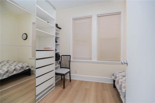 bedroom with light wood-type flooring and baseboards