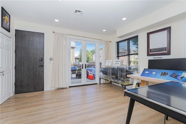 recreation room featuring light wood-type flooring, french doors, visible vents, and recessed lighting