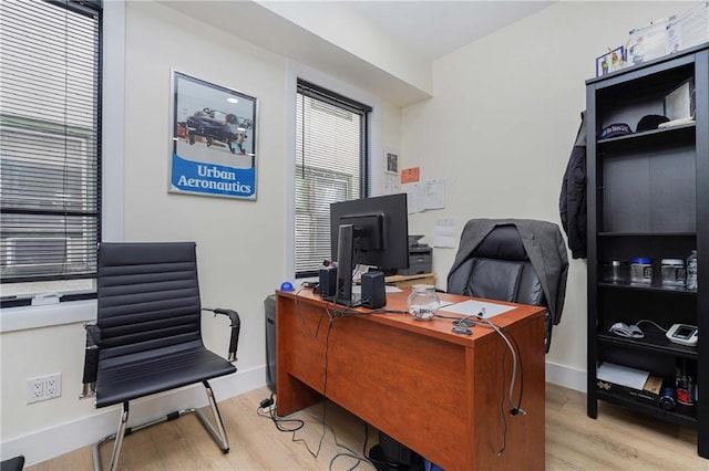 office featuring light wood-type flooring and baseboards