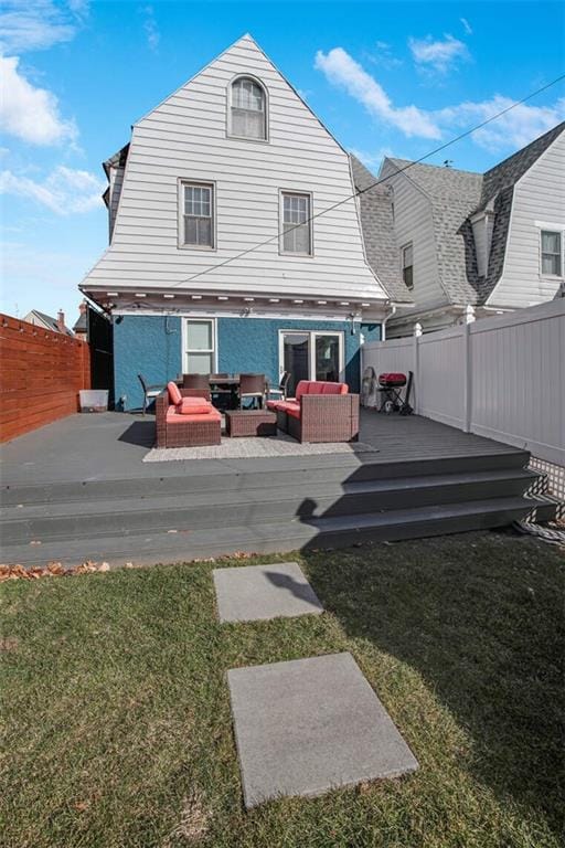 back of house featuring a wooden deck, a yard, and an outdoor hangout area