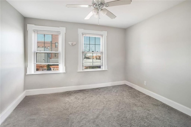 carpeted empty room featuring a wealth of natural light and ceiling fan