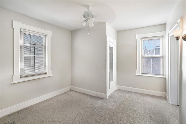 unfurnished room featuring light carpet and ceiling fan