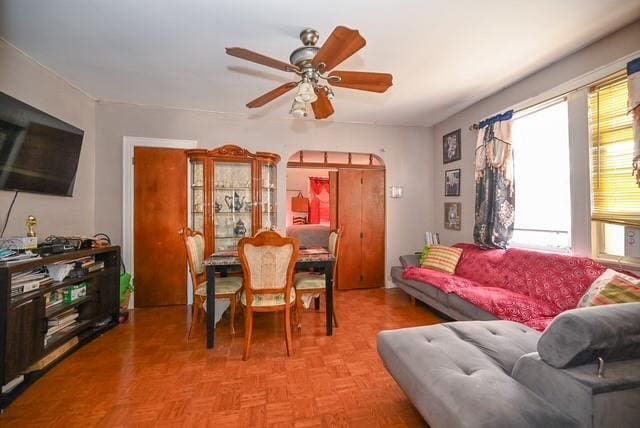 living room featuring ceiling fan and light parquet floors