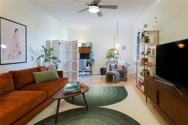 living room with ceiling fan, ornamental molding, and light hardwood / wood-style flooring