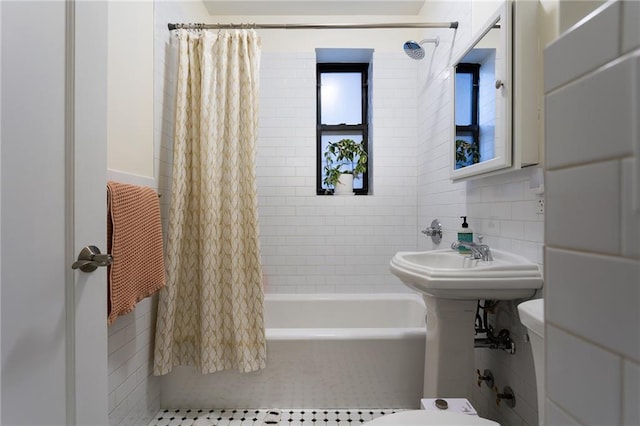 full bath featuring toilet, tasteful backsplash, tile walls, and shower / bath combination with curtain